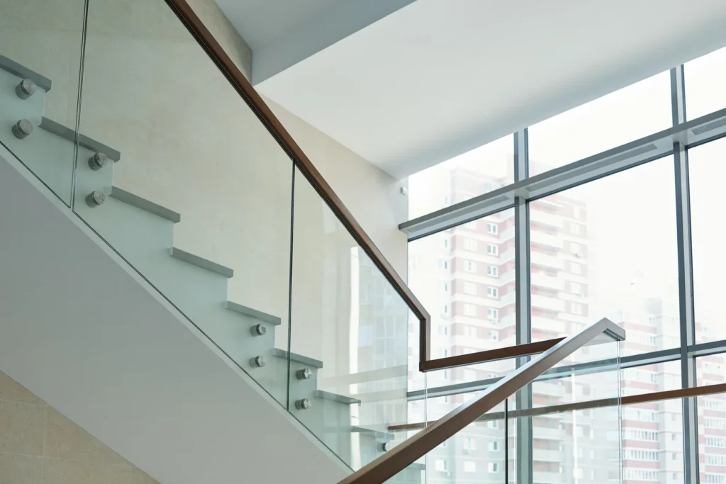 Interior glass stair railing letting natural light through the staircase